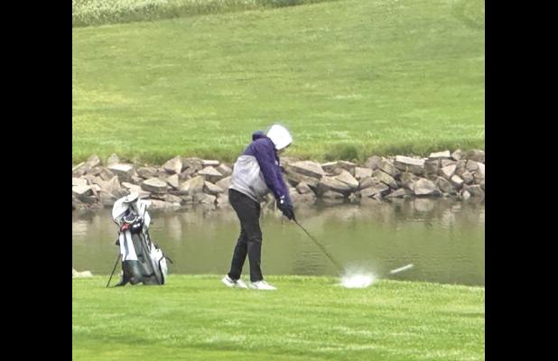 Jeremy Fehringer makes a splash on the wet greens at the district meet last week at Southern Hills Golf Course after the area received enough rain to make the course a squishy challenge to play on. (–courtesy photo)