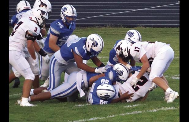 A herd of Buffaloes corral a Sutton Mustang ball carrier during last week’s football game. (—photo by Alissa Baxter)