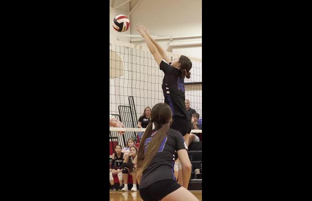 Gibbon’s Cove Fries goes up for a block in recent Lady Buffalo volleyball action. (—photo by Alissa Baxter)