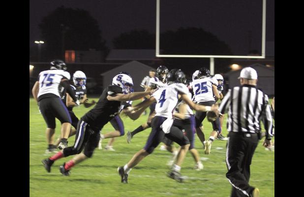 Bulldog defensive lineman Dominick Larraga puts the pressure on the Newman Grove/St. Edward quarterback during Shelton’s 48-0 win last Friday night. (—photo by Steve Glenn)