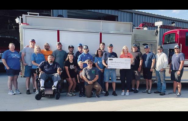 Stephanie King, representing Black Hills Energy, presents a check for $2,000 to members of the Gibbon Volunteer Fire Department as part of the Black Hills’ Funds for Firefighters program. According to the grant application, “The Gibbon Fire Department