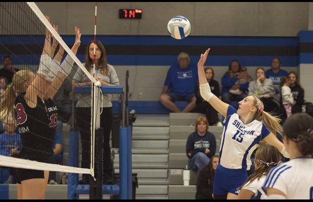 Olivia Kennedy strategically pushes a kill past the outstretched arms of two Deshler blockers in the Lady Bulldogs’ four set homecoming win last Thursday night. (—photo by Jeanette Branson)