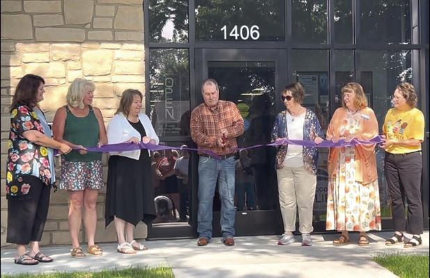 The community of Wood River held the grand opening ribbon cutting ceremony for the new Legacy Station on Saturday morning. Helping Wood River Mayor Greg Cramer (center) with the task were, from left to right, Kila Turek, Nancy DeVore, Veronica Kaufman, Lo