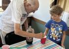 Verne Hickok (left) makes one of his famous root beer floats for a youngster. Mr. Hickok was recently among those who received recognition for their volunteer work with a Step Forward Award. (–courtesy photo) Article Image Alt Text