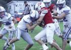 Gibbon’s Riley Bergstrom puts his shoulder into the Amherst ball carrier for a tackle as teammates Lukas Altwine (#24) and Adan Tamayo converge to help. (—photo by Alissa Baxter)
