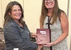 Kim Wadkins, left, a member of the Gibbon School Board, was recently presented a plaque by Lisa Wagner, right, a member of the NASB Board of Directors, for achieving level eight of the NASB’s Awards of Achievement program. (—courtesy photo)