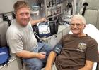 EMTAdam Woitaszewski and “patient” Nick Lammers demonstrate the cardiac monitor that the Wood River Fire Department recently purchased using funds from a $10,000 grant from the WRCCF. (—courtesy photo)