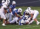 A herd of Buffaloes corral a Sutton Mustang ball carrier during last week’s football game. (—photo by Alissa Baxter)