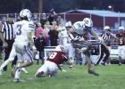 Adan Tamayo jumps through an Amherst tackle attempt as brother and teammate Ivan Tamayo looks on. (—photo by Alissa Baxter)