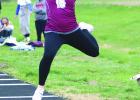 Kyra Wooden prepares for a landing while competing in, and winning, the long jump event at the Gibbon Invite. (—photo by Jeanette Branson) Article Image Alt Text