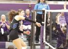 Shelton senior Erin Gegg goes high to power a spike past the net and the opponent’s block attempt during volleyball action last week. (—photo by Jeanette Branson)
