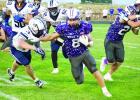 Eagle running back Gavyn Johnson stiff arms his way around a Lincoln Lutheran tackler. (—photo by Andrea Johnson)