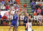 Shelton’s Kellen Gegg (#11) and Zach Myers (#10) stretch to claim a lose ball when the Bulldogs clashed with the Medicine Valley Raiders in the D2-8 District Championship at Lexington last week. (–photo by Steve Glenn) Bulldogs earn spot at state tournament at expense of Raiders