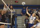 Olivia Kennedy strategically pushes a kill past the outstretched arms of two Deshler blockers in the Lady Bulldogs’ four set homecoming win last Thursday night. (—photo by Jeanette Branson)