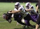 A host of Eagle tacklers, led by Ikaiah Edgren, stop a Doniphan/Trumbull ball carrier. Article Image Alt Text