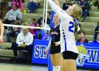 Emma Clark receives a serve in action at the St. Paul Triangular on Thursday, October 23. (—photo by Andrea Johnson)