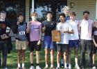 The Shelton boys cross country team celebrates with the conference championship plaque after awards were given out at the Franklin Country Club. (—courtesy photo)