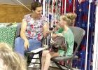Karrington Rolfsmeyer showed in her last Clover Kid Shows with her sheep and goats at this year’s Buffalo County Fair. She also had Clover Kid Show and Tell with Coco. Buffalo County Extension Assistant Heidi Darby (left) is facilitating the show and te
