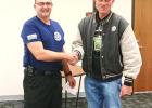 Dannebrog Boelus EMT Captain Terry Webb, left, accepts a donation from John Brezina. (—courtesy photo) Webb presented with live saving award at December meeting