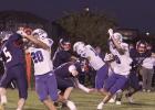 Reilly Jensen (#20) and Demarion Williams (center) block for Ben Myers (right) to gain valuable yardage against Heartland Lutheran. Myers amassed 238 yards on the ground in the win over the Hornets on the road in Grand Island. (–photo by Steve Glenn) Article Image Alt Text