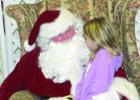 The Boelus Community Christmas Party welcomed Santa Claus (Gene Khyn) who invited the children to come and whisper their Christmas desires in his ear. (–courtesy photo)