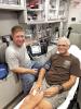 EMTAdam Woitaszewski and “patient” Nick Lammers demonstrate the cardiac monitor that the Wood River Fire Department recently purchased using funds from a $10,000 grant from the WRCCF. (—courtesy photo)