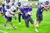 Eagle running back Gavyn Johnson stiff arms his way around a Lincoln Lutheran tackler. (—photo by Andrea Johnson)